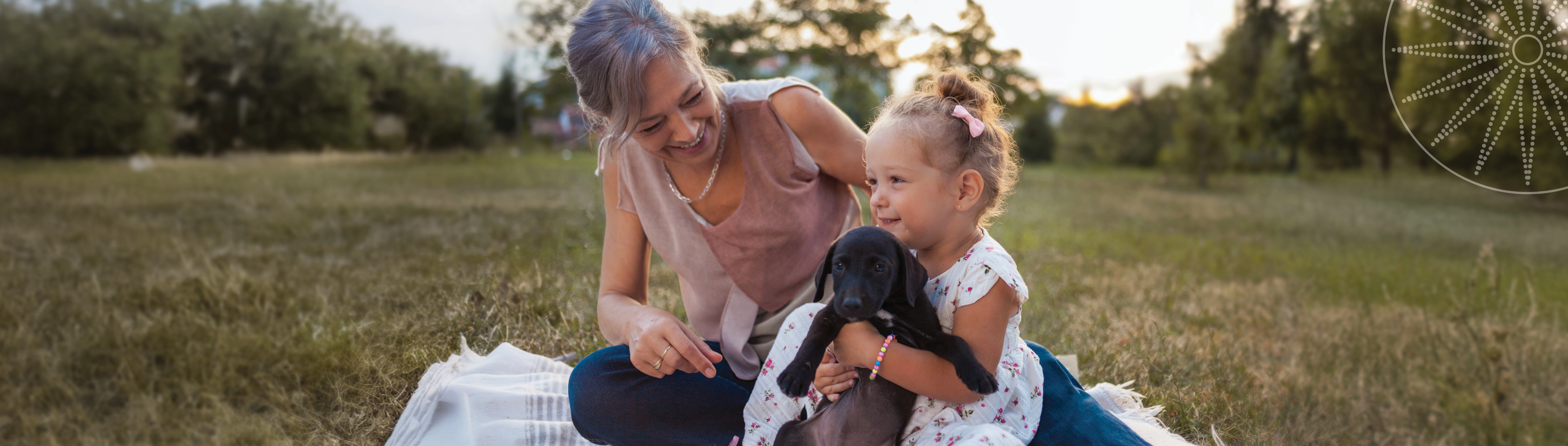 woman with a girl holding a puppy